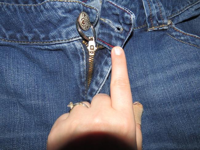 Inside the zipper of every pair of Lucky jeans. I already knew it was  there. Don't ask how.