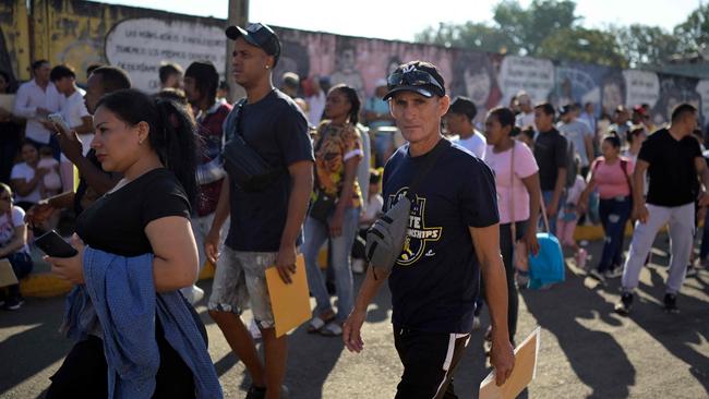 Migrants outside the regional office of the National Migration Institute to await their safe conduct to transit through Mexican territory on their way to the United States on January 13. Picture: Alfredo Estrella/AFP