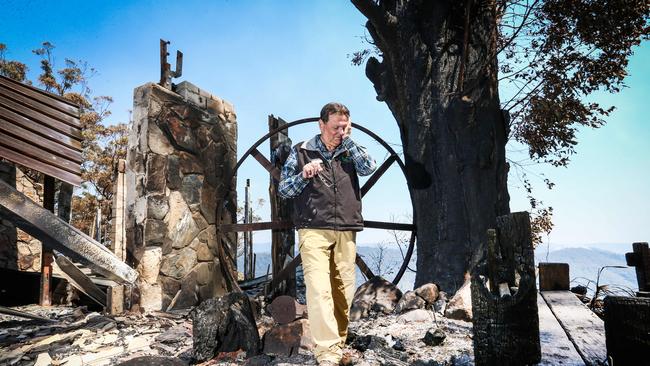 Binna Burra Lodge's Steve Noakes inspecting the ruins of the property after last year’s fires. Picture: Nigel Hallett