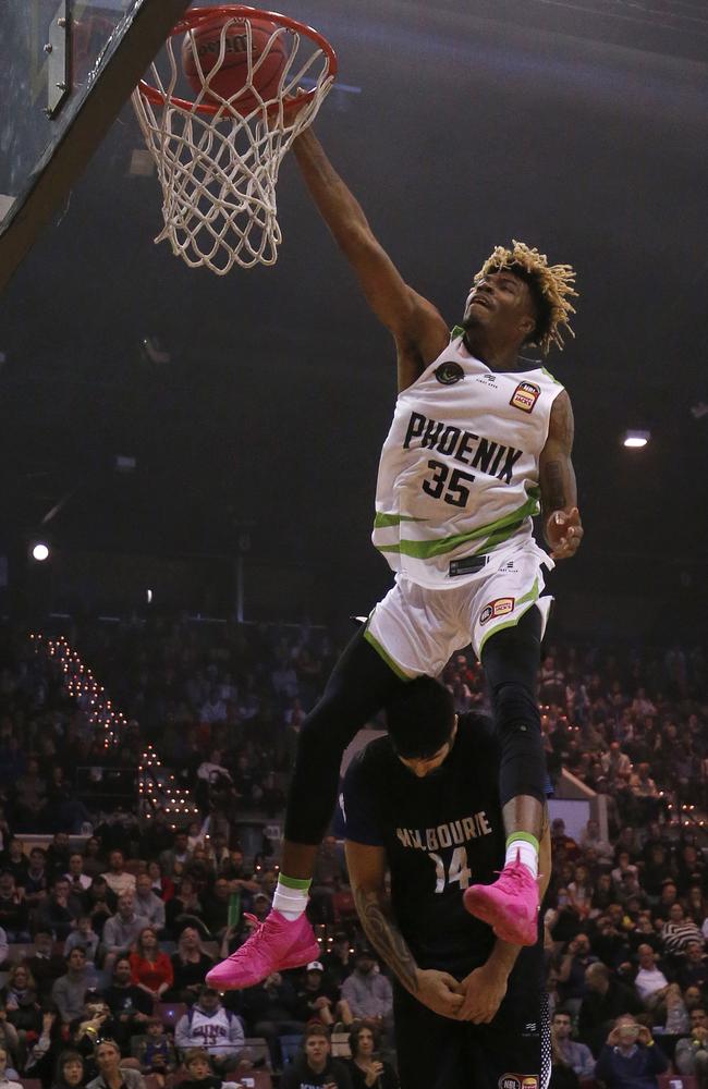 Terry Armstrong wins the NBL Blitz Dunk Comp earlier this year, jumping over Melbourne United big man Tohi Smith-Milner. Picture: Getty Images