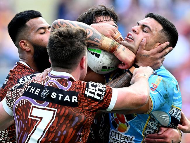 BRISBANE, AUSTRALIA - MAY 26: David Fifita of the Titans is wrapped up by the defence during the round 12 NRL match between Brisbane Broncos and Gold Coast Titans at Suncorp Stadium, on May 26, 2024, in Brisbane, Australia. (Photo by Bradley Kanaris/Getty Images)