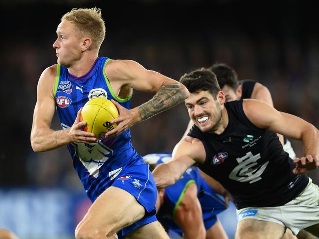 MELBOURNE, AUSTRALIA - APRIL 07: Jaidyn Stephenson of the Kangaroos is tackled by George Hewett of the Blues  during the round four AFL match between North Melbourne Kangaroos and Carlton Blues at Marvel Stadium, on April 07, 2023, in Melbourne, Australia. (Photo by Quinn Rooney/Getty Images)