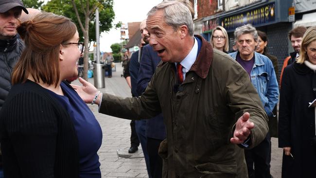 Leader of Reform UK Nigel Farage speaks to a member of the public during a visit to Ashfield. Picture: AFP.