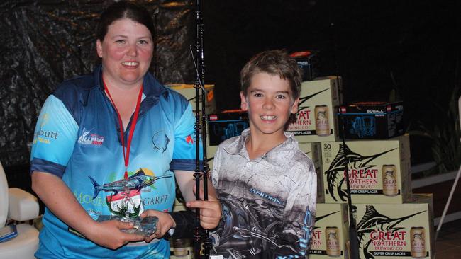 Mackay's Matthew Colborne collects up his Townsville Billfishing Challenge junior champion trophy from Renee McKenzie, secretary of the Townsville Gamefishing Club