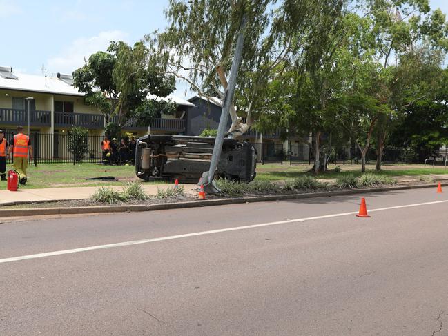 A rolled car at Nightcliff on Sunday caused significant damage to a nearby light pole. Picture: Sam Lowe