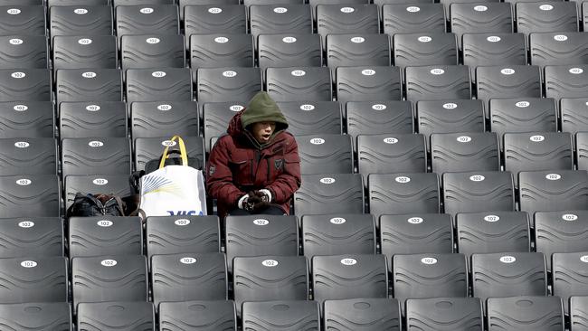 A fan sits alone at the 10,200-seat capacity Phoenix Snow Park, where wind is playing havoc with the schedule.