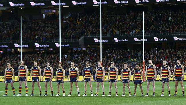 And this was only 14 of them ... Crows players stand like warriors during the national anthem. Picture: Sarah Reed