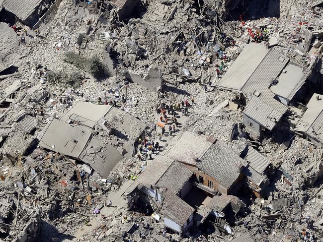 Rescuers search amid rubble following the earthquake in Amatrice. Picture: AP / Gregorio Borgia