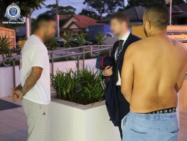 A detective speaks to two men arrested in relation to an alleged 'dial-a-dealer' drug syndicate in northwest Sydney. Picture: NSW Police