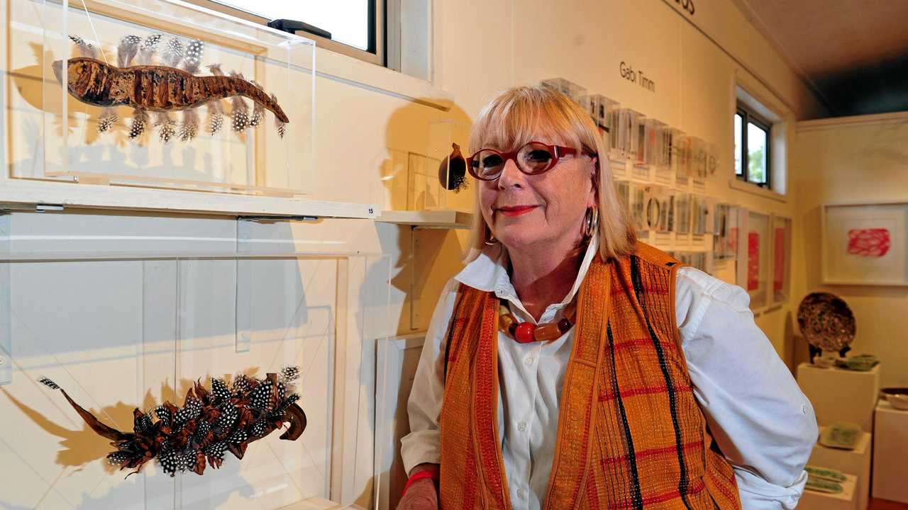 Artist Sue Coburn with an example of her work at a Floating Land exhibition in Boreen Point. Picture: Geoff Potter