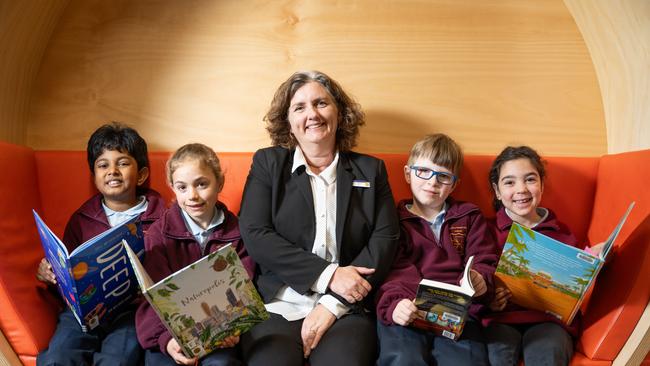 Acting principal Monique Egan reads with year 3/5 students, Bjanuka, Mila, Ryan and Liz at St Vincent's Primary School in Canberra. Picture: Martin Ollman