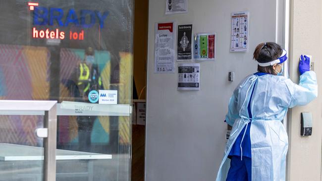 A person in PPE wipes down services at the Brady Hotel. Picture: Tim Carrafa/NCA NewsWire.