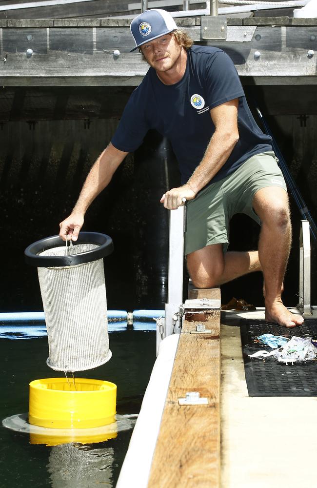 CEO of The Seabin Project Pete Ceglinksi pulls the filter bag from one of the machines. Picture: John Appleyard