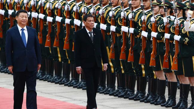 Chinese President Xi Jinping and Philippines President Rodrigo Duterte review the guard of honours at the Great Hall of the People in Beijing in 2016. Picture: Thomas Peter/AFP