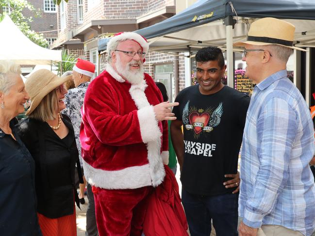 From left, Prof. Kerryn Phelps, Lucy Turnbull, Santa, Wayside CEO and Pastor Jon Owen and former prime minister Malcolm Turnbull at the annual Wayside Chapel's Christmas Party. Picture: Richard Dobson