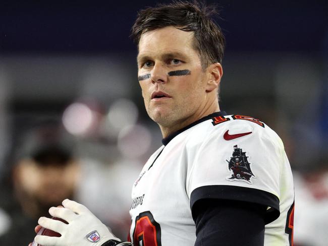 (FILES) In this file photo taken on October 2, 2021 Tom Brady #12 of the Tampa Bay Buccaneers warms up on the sideline during the game against the New England Patriots at Gillette Stadium  in Foxborough, Massachusetts. - Tom Brady's return October 3, 2021 to face his former NFL team, the New England Patriots, racked up enormous American viewing numbers making it one of the most watched "Sunday Night Football" games in history. (Photo by Maddie Meyer / GETTY IMAGES NORTH AMERICA / AFP)