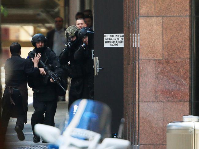 A hostage runs out towards the officers. Picture: Toby Zerna