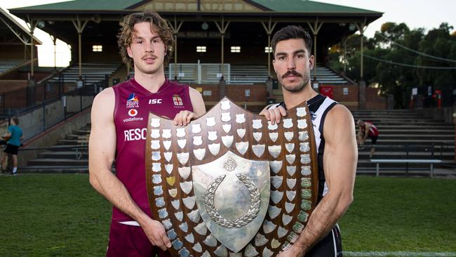 PAOC’s Lochie Charlton and PNU skipper Jon Giannini with the Adelaide Footy League division one premiership shield. Picture Mark Brake