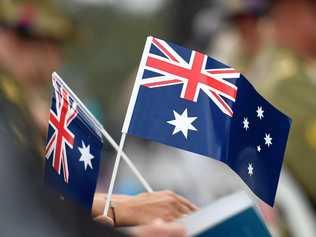 Memmbers of the public hold flags at an Australia Day Citizenship Ceremony and Flag Raising event in Canberra on Tuesday, Jan. 26, 2016. (AAP Image/Mick Tsikas) NO ARCHIVING. Picture: MICK TSIKAS