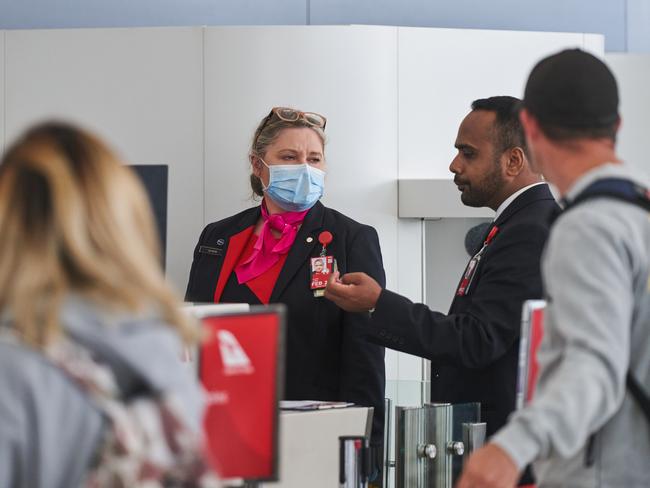 Qantas staff and passengers at Adelaide Airport Tuesday, March 31, 2020 after news six baggage handlers had tested positive for the virus. Picture: Matt Loxton