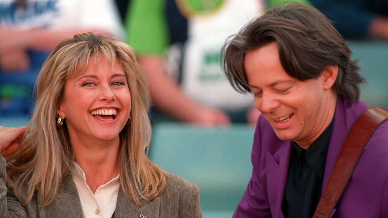 In 1992 Newton-John was diagnosed with breast cancer. She underwent a partial mastectomy, chemotherapy and breast reconstruction to recover and became an advocate for breast cancer research. She is pictured here with guitarist Tommy Emmanuel at the 1994 Rugby League Grand Final.