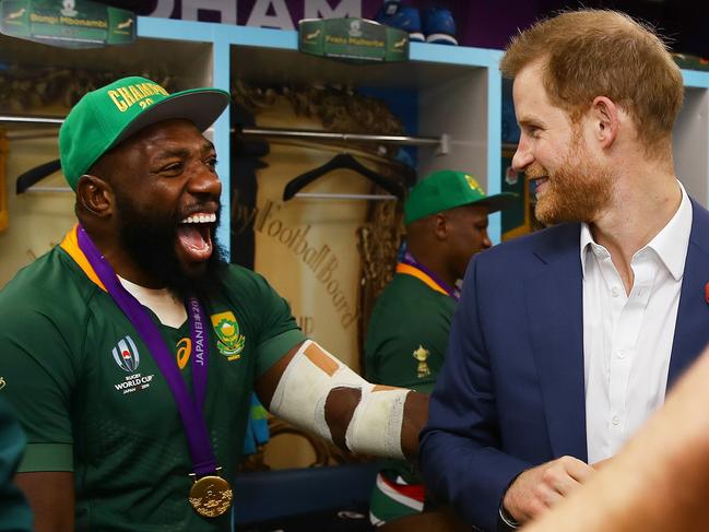 Prince Harry shares a joke with Tendai Mtawarira of South Africa following his team's victory against England in the Rugby World Cup. Picture: Getty