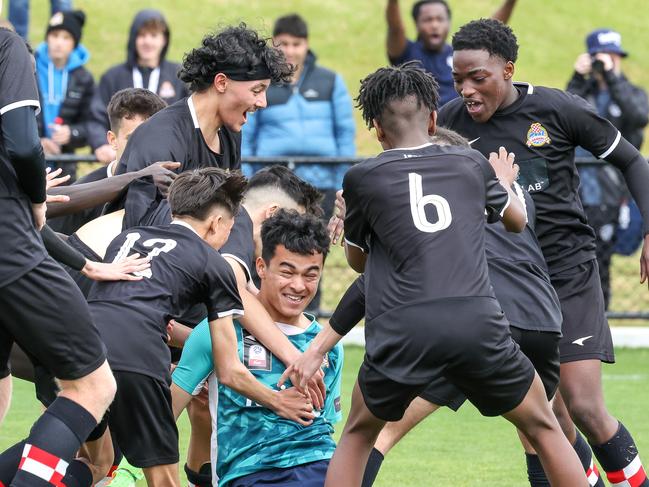 Adelaide Croatia Raiders players celebrate following the penalty shootout in the Football SA Junior Boys Under-17 Cup final. Picture: Adam Butler