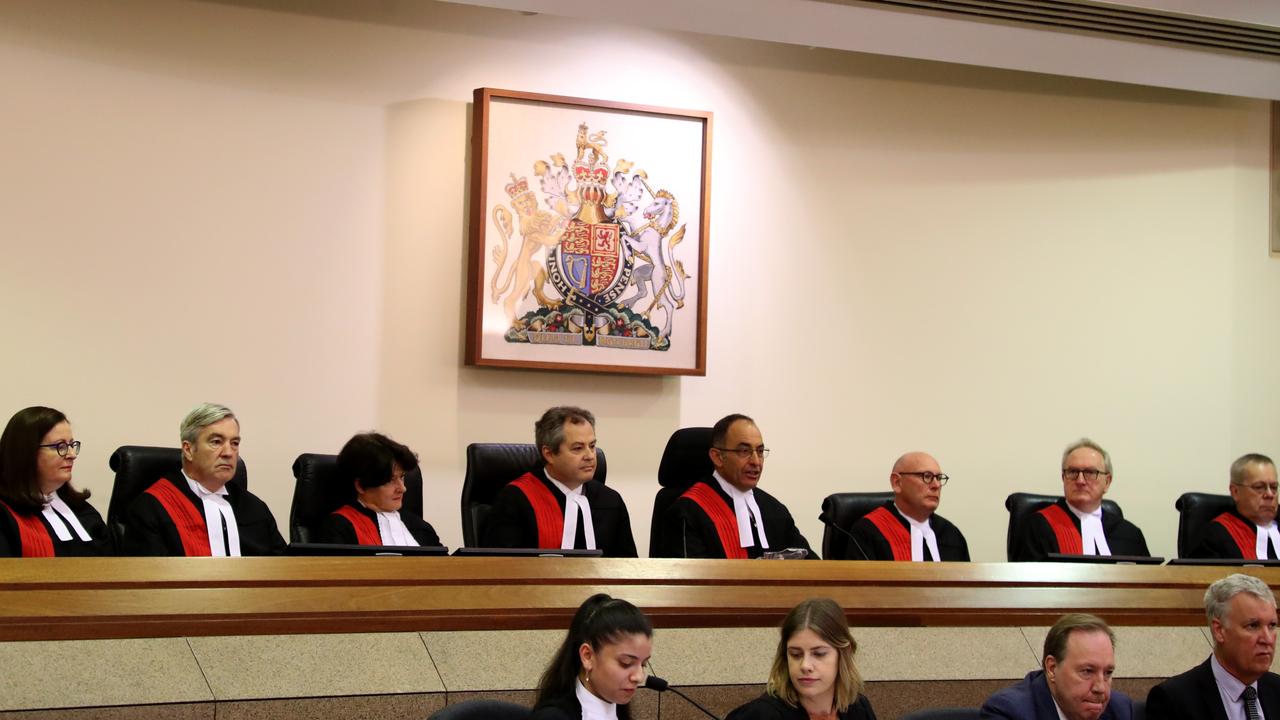 The Supreme Court sitting in 2020 following the appointment of now Court of Appeal president Mark Livesey to the bench. The court sits in front of the coat of arms featuring the coat of arms.