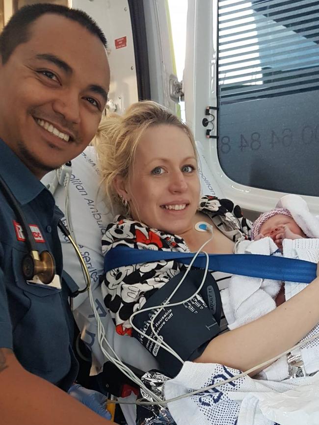 Mum Jessica Nix, baby Hudson and a paramedic.