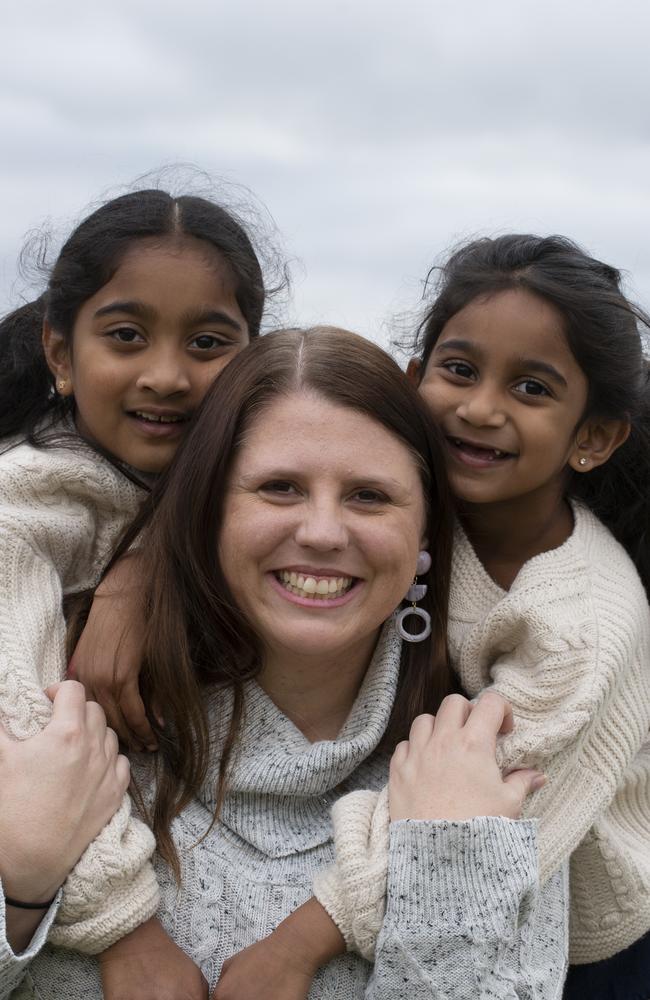 Kopika, 7, and Tharnicaa, 5, with their friend Angela Fredericks, a mental health social worker, in Biloela. Picture: Russell Shakespeare