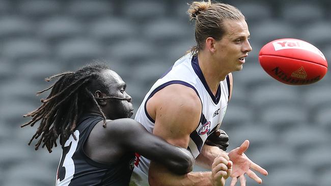 Fremantle star Nat Fyfe is run down by Anthony McDonald-Tipungwuti. Picture: Michael Klein