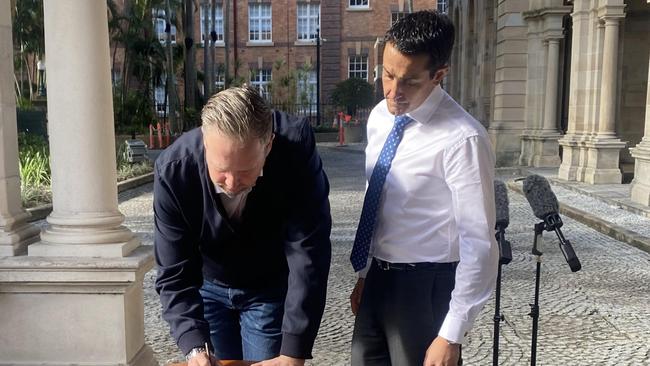 Ben Cannon with Opposition leader David Crisafulli signing the youth crime laws petition outside Parliament House. Picture: Samantha Scott