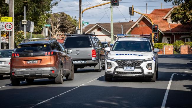 Police drive past the school where a boy was allegedly abducted and assaulted in an effort to increase patrols. Picture: Jake Nowakowski