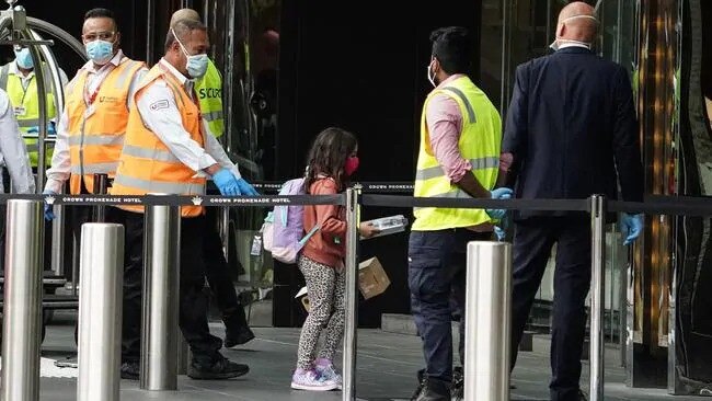 Security officers assist newly arrived overseas travellers at the Crown Promenade Hotel in Melbourne in March