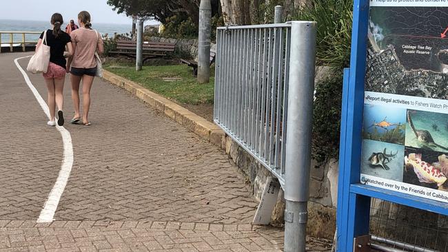 Northern Beaches Council has installed a temporary steel gate to stop people using Marine Pde, the shared pedestrian and cycle path between Manly and Shelly beaches, during expected stormy weather and large swells later this week. Picture: Jim O'Rourke