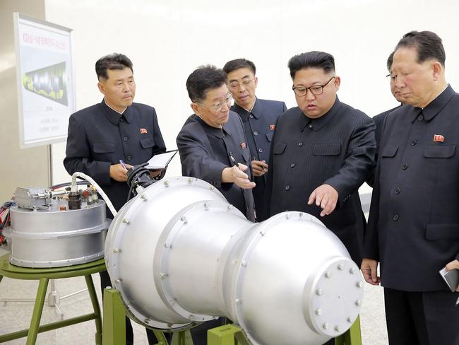 North Korean leader Kim Jong-un looking at what was said to be a model of a miniaturised nuclear warhead. North Korea's latest nuclear test was around 160 kilotons — more than ten times the size of the Hiroshima bomb. Picture: AFP / KCNA via KNS