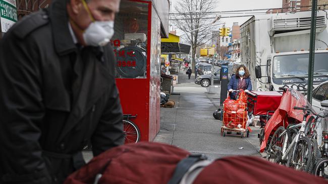 Funeral director Tom Cheeseman retrieves a body on a house call in New York last week. Picture: AP