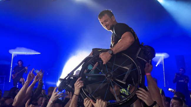 A man in a wheelchair crowd-surfs during Psycroptic's set at Full Tilt Festival at Reunion Park in Melbourne. Picture: Kiel Egging.