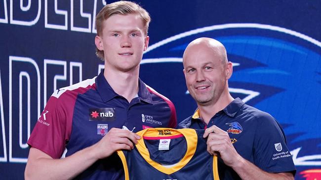 Sixth AFL Draft pick Fischer McAsey is presented with a guernsey by Adelaide Crows coach Mathew Nicks. Picture: AAP Image/Michael Dodge.