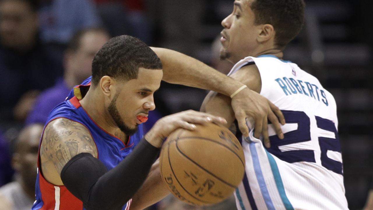 Detroit Pistons' D.J. Augustin, left, pushes past Charlotte Hornets' Brian Roberts during the first half of an NBA basketball game in Charlotte, N.C., Tuesday, Feb. 10, 2015. (AP Photo/Chuck Burton)