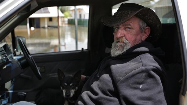 Brad Fox and his dog have been forced out of their home by floodwaters. Picture: Dean Marzolla