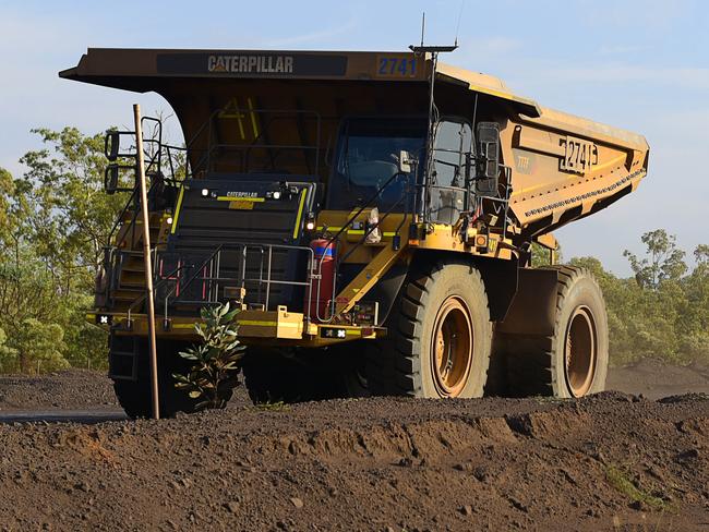 A haul truck drives past a crossing at South32's GEMCO manganese mining operation on Groote Eylandt.