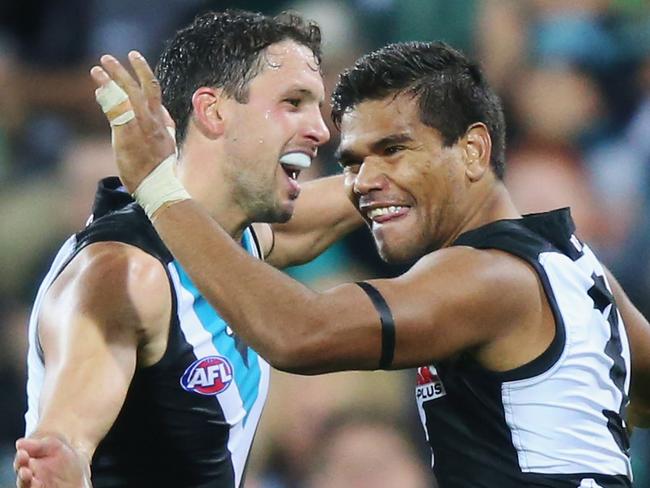 Jake Neade of the Power celebrates a goal with Travis Boak.