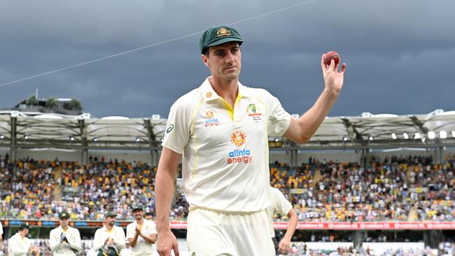 Pat Cummins shows the ball to the crowd after his five-wicket haul at the Gabba