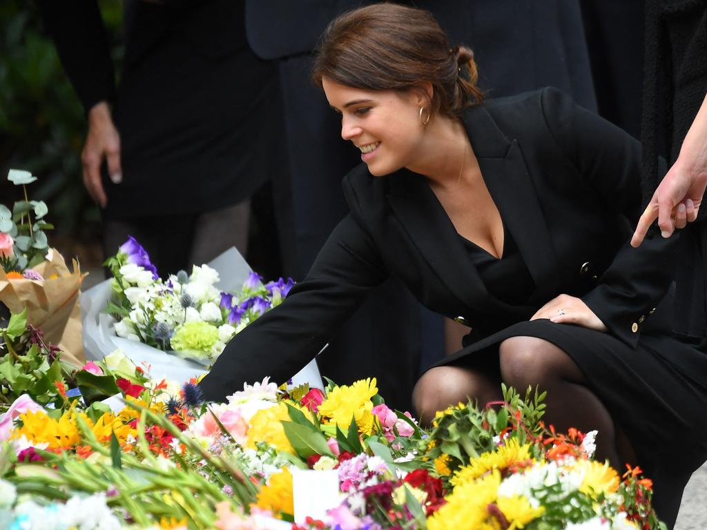 Princess Eugenie looks at the many tributes. Picture: AFP