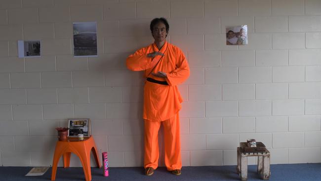 Andrew Wong stands between shrines for his dad and the Lungs.