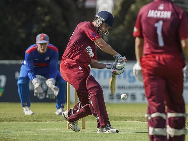 Mornington keeper Charlie Parker watches Red Hill batsman Luke Robertson crack a drive. Picture: Valeriu Campan