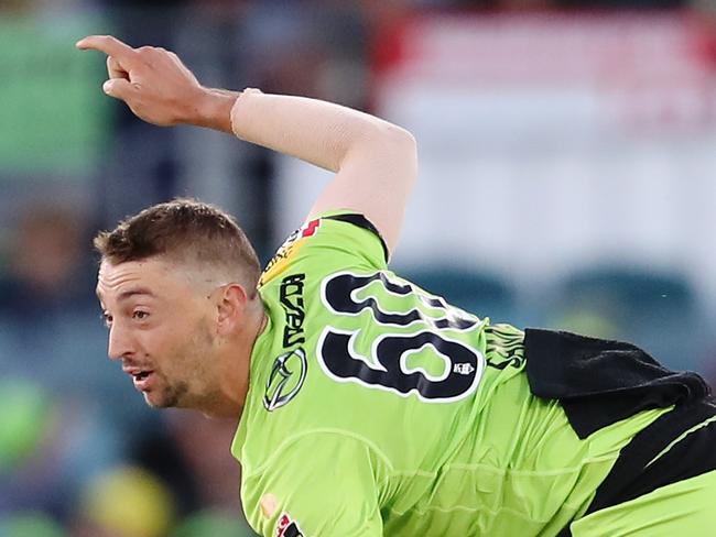 CANBERRA, AUSTRALIA - DECEMBER 14: Daniel Sams of the Thunder   bowls during the Big Bash League match between the Sydney Thunder and the Brisbane Heat at Manuka Oval, on December 14, 2020, in Canberra, Australia. (Photo by Brendon Thorne/Getty Images)