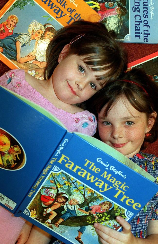 PIRATE: Erin McAuley (l) with sister Claire reading book |The Magic Faraway Tree| by Enid Blyton. children child