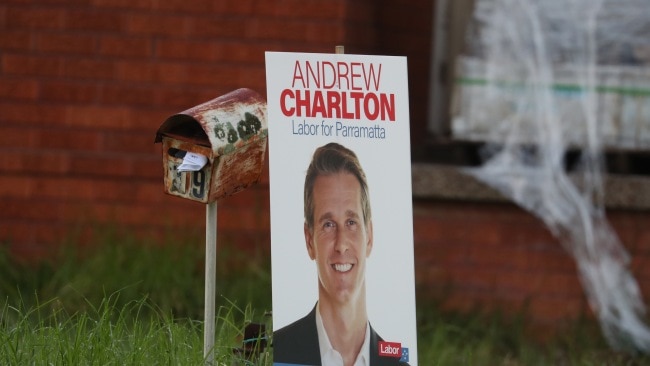 Neighbours of Andrew Charlton have posters planted in their front yards in North Parramatta. Picture: John Grainger